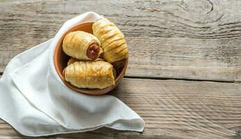 Bowl with sausage rolls photo