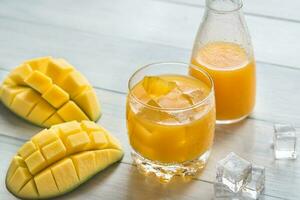 Mango juice on the wooden table photo