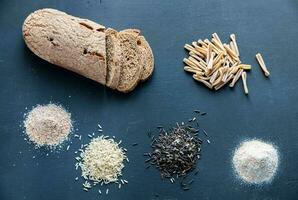 Wholegrain products on the dark wooden background photo