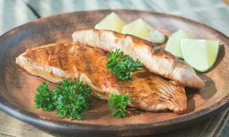 Roasted salmon steak with fresh parsley photo