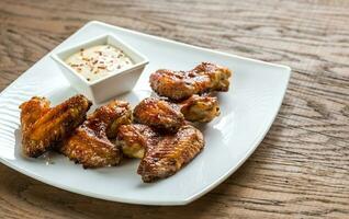 Baked chicken wings with spicy sauce photo