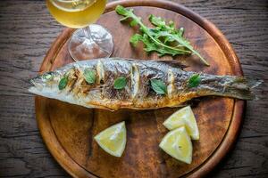 Grilled seabass on the wooden board photo