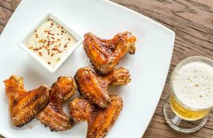 Baked chicken wings with spicy sauce photo