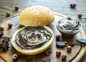 Seasame bun with chocolate cream and nuts photo