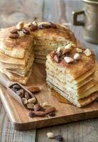 Stack of pancakes with butter and maple syrup photo