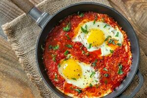 Shakshouka served in a frying pan photo