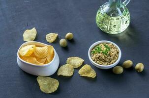 Potato chips with olive pate photo