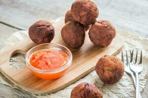 Chicken meatballs with spicy thai sauce photo