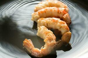 Fried shrimps on the black background photo