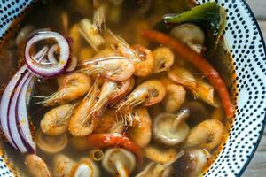 Bowl of thai tom yum soup photo