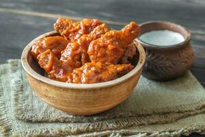 Bowl of buffalo wings with blue cheese dip photo