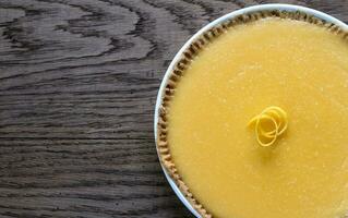 Lemon tart on the wooden background photo