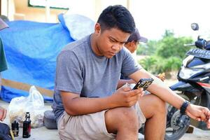 Kuaro Kalimantan timur.indonesia 01 May 2023. an asian man is using a smartphone photo