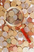 Magnifying glass with coins photo