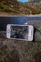 Broken phone on rocks photo