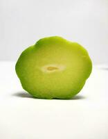 A slice of chayote isolated on white background photo