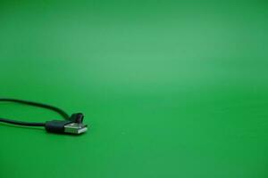 USB type A cable to USB micro B cable isolated green background. photo