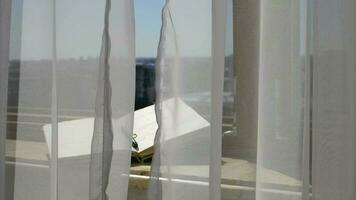 Diary with a pen at marble sill of an open window. Blowing grey transparent curtains video