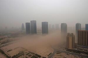 City's skyline is barely visible through the thick cloud of dust. photo
