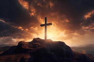 Cross on the top of the mountain with sunset background. photo