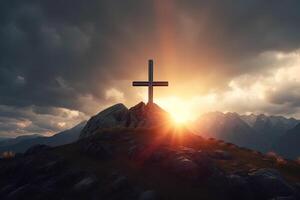 Cross on the top of the mountain with sunset background. photo