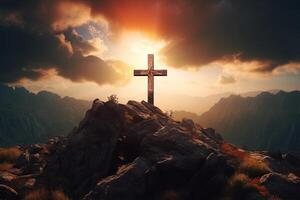 Cross on the top of the mountain with sunset background. photo