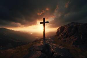 Cross on the top of the mountain with sunset background. photo