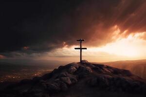 Cross on the top of the mountain with sunset background. photo