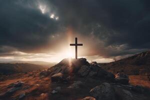 Cross on the top of the mountain with sunset background. photo