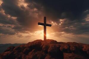 Cross on the top of the mountain with sunset background. photo