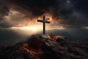 Cross on the top of the mountain with sunset background. photo