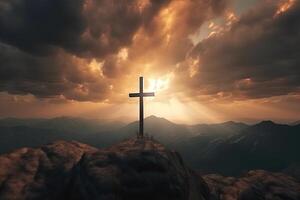 Cross on the top of the mountain with sunset background. photo