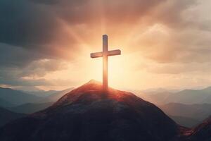 Cross on the top of the mountain with sunset background. photo