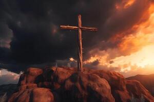 Cross on the top of the mountain with sunset background. photo