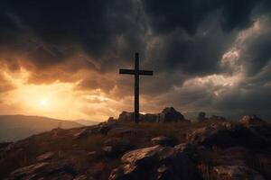Cross on the top of the mountain with sunset background. photo
