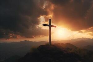 Cross on the top of the mountain with sunset background. photo