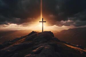 Cross on the top of the mountain with sunset background. photo