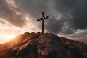 Cross on the top of the mountain with sunset background. photo