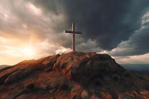 Cross on the top of the mountain with sunset background. photo