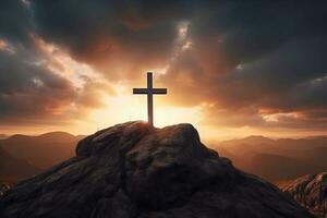 Cross on the top of the mountain with sunset background. photo