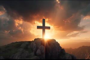 Cross on the top of the mountain with sunset background. photo