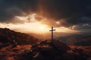 Cross on the top of the mountain with sunset background. photo