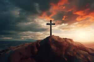 Cross on the top of the mountain with sunset background. photo