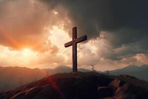 Cross on the top of the mountain with sunset background. photo