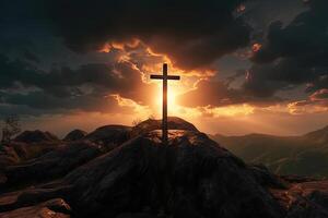 Cross on the top of the mountain with sunset background. photo