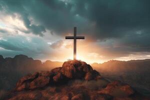 Cross on the top of the mountain with sunset background. photo