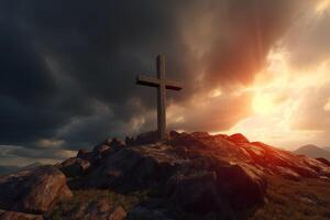 Cross on the top of the mountain with sunset background. photo