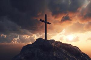 Cross on the top of the mountain with sunset background. photo