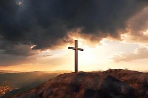 Cross on the top of the mountain with sunset background. photo