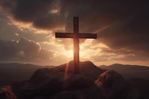 Cross on the top of the mountain with sunset background. photo